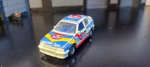 Yellow, blue and white vintage diecast car model with racing-style decals