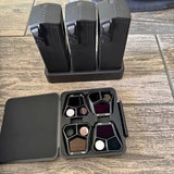Drone accessory case with compartments and three batteries, plus cables and adapters