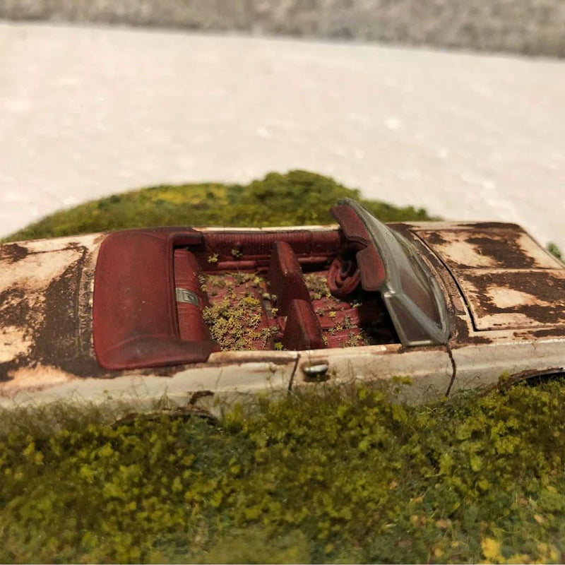 Weathered rusty 1965 Chevy Impala SS convertible diecast car, open door and interior