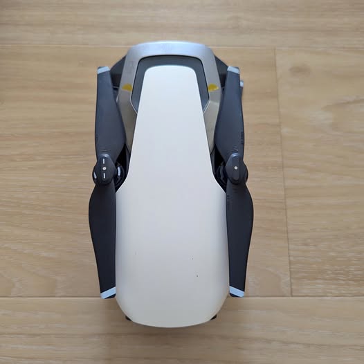 DJI Mavic Air drone, white body with folded front arms and landing gear