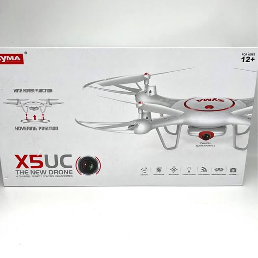 Gray RC quadcopter drone with 4 rotors and front camera lens