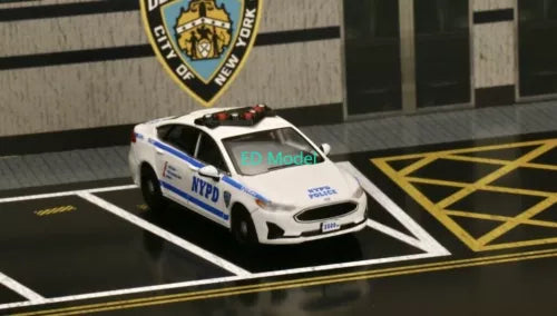 White NYPD police interceptor diecast model car with blue stripe, front 3/4 view