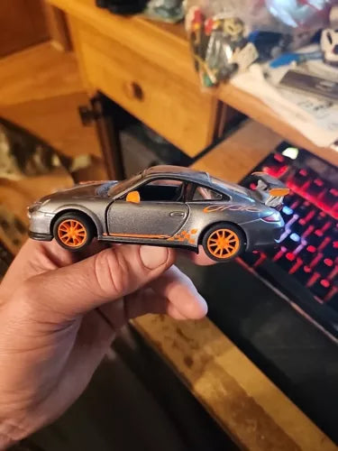 Gray 1:36 scale diecast toy car with orange wheels, Porsche 911 GT3 RS, pull-back action