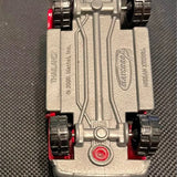 Matchbox Nissan Xterra diecast vehicle underside with silver chassis and red wheels
