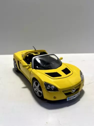 Yellow Maisto 1:18 diecast sports car with black hood stripes