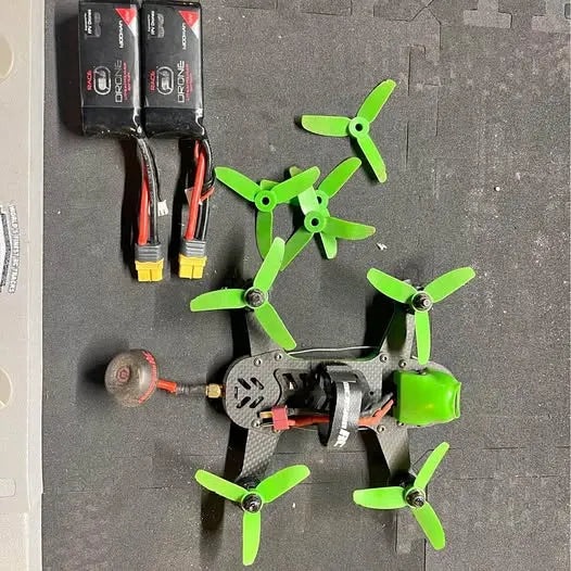 Quadcopter drone with green propellers and black frame