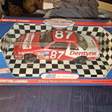 Diecast racing car model with red hood and number 87 Dentyne on black-white checkers
