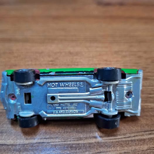 Diecast Plymouth PA die-cast toy car underside, Hot Wheels logo, blue chassis, black wheels
