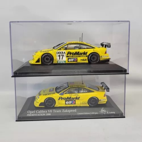 Set of 2 yellow racing diecast car models in clear display case