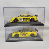 Set of 2 yellow racing diecast car models in clear display case