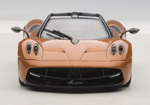 Bronze diecast sports car model with black grille and teardrop headlights