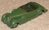 Vintage diecast toy car in dark green with windshield and open cockpit detail