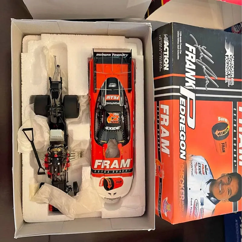 Diecast race car model with engine detail, orange and white body in box