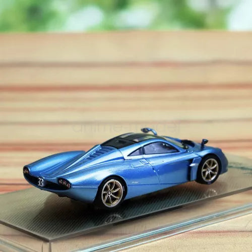 Blue die-cast sports car model with black details, front three-quarter view.
