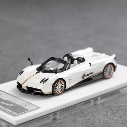 White convertible sports car model with black wheels and side decals, on display base