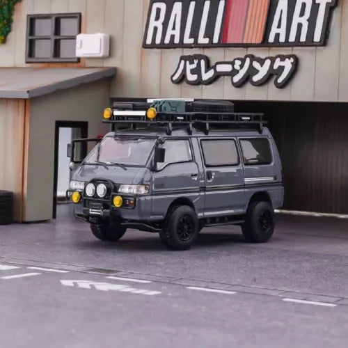 Grey off-road mini van diecast toy car, front three-quarter view, detailed grille and lights