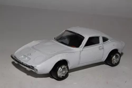 White diecast model car with chrome wheels and black windows