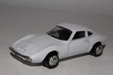 White diecast model car with chrome wheels and black windows