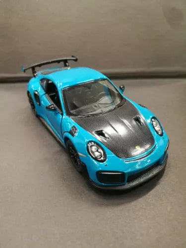 Turquoise diecast toy car with open doors, 1/36 scale