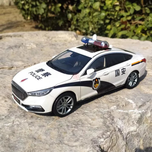White police die-cast sedan model with blue/red light bar and front grille detail
