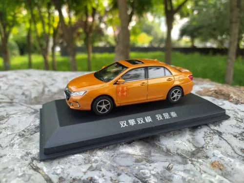 Orange BYD QIN PRO DM diecast sedan model car on display base