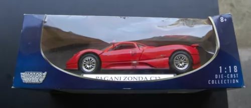 Red 1/18 diecast model car in box with clear display window and blue packaging
