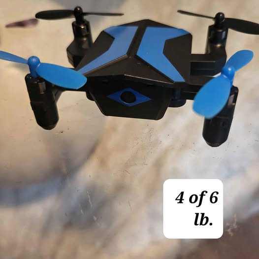 Kids camera drone with black body and blue propellers, four rotors