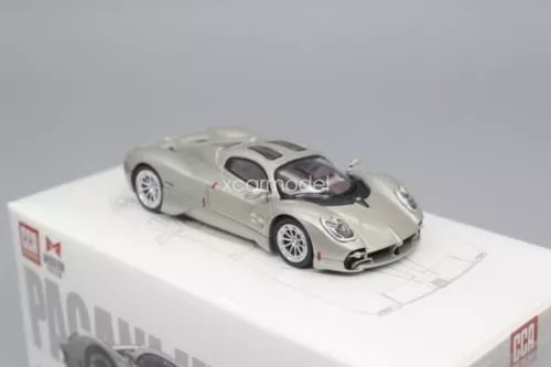 Metallic sports diecast car model on white display base, front 3/4 view