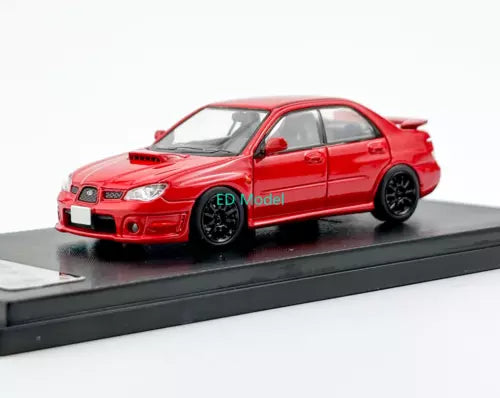 Red sedan diecast model car toy, front 3/4 view on dark display base