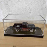 Black diecast 1983 Silverado model truck in clear display case