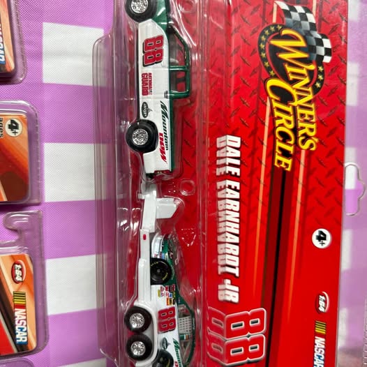 Red and white die-cast race car in blister packaging
