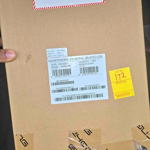 Cardboard shipping box with white barcode label and product info