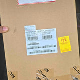 Cardboard shipping box with white barcode label and product info