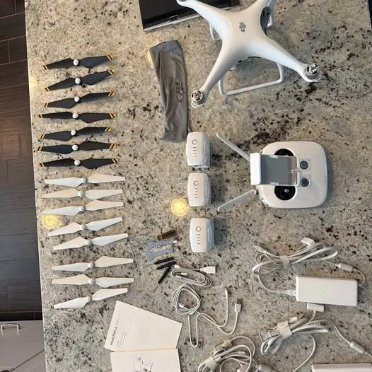 DJI Phantom 4 drone bundle with drone, controller mount, batteries, charger, cables, props
