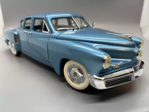 Blue 1948 Tucker Torpedo diecast model car, front three-quarter view with chrome grille