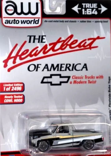 Die-cast 1:64 Chevrolet Silverado toy truck, black with white racing stripes.