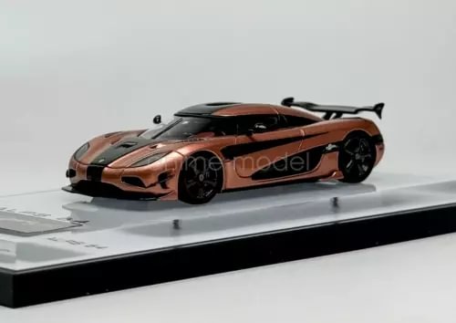Orange 1:64 sports race car diecast model with black wheels and rear spoiler