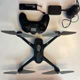 Black quadcopter drone with four propellers and front camera module