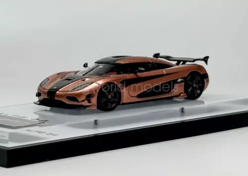 Sports car diecast model in orange with black accents, black wheels, front 3/4 view