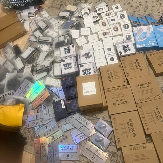 Assorted boxed electronics parts, including small devices and accessory packaging.