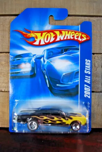 Diecast car in blue blister package, flame graphics and Hot Wheels logo on card