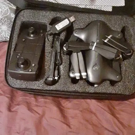 Quadcopter drone and remote controller in foam carrying case