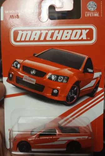 Orange Matchbox Holden ute diecast model in blister pack, front view