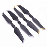 Low-noise propeller blade set with dark blades and gold tips, includes 4 blades