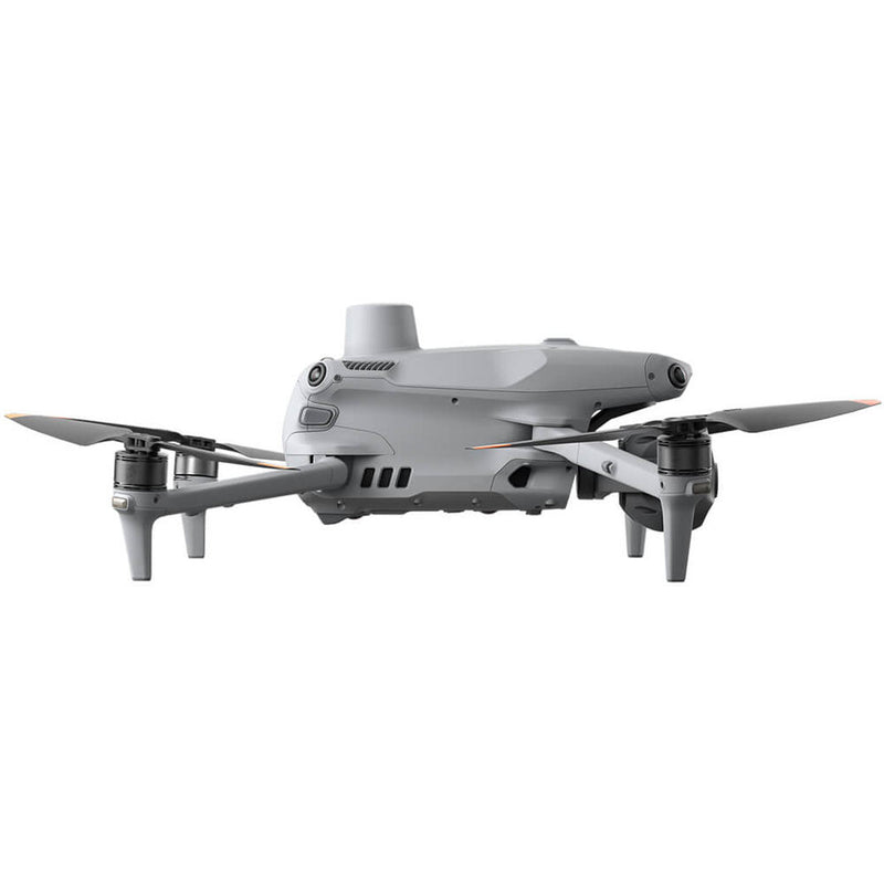 Gray quadcopter drone with four propellers and retractable landing legs, front view