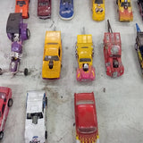 Diecast drag car collection with multiple miniature cars, yellow, red, purple, and more.