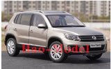 Diecast SUV model car, silver-gray with red wheel accents, front 3/4 view