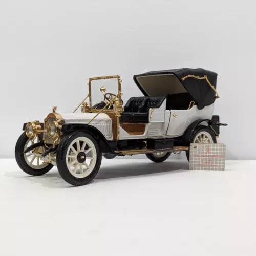 1:24 diecast model car with open top, gold and white, detailed dashboard and wheels