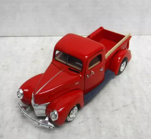 Red 1940 Ford pickup diecast truck, 1:24 scale, front three-quarter view with chrome grille