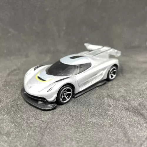 White diecast sports car with black wheels, tinted windows, and yellow racing stripe